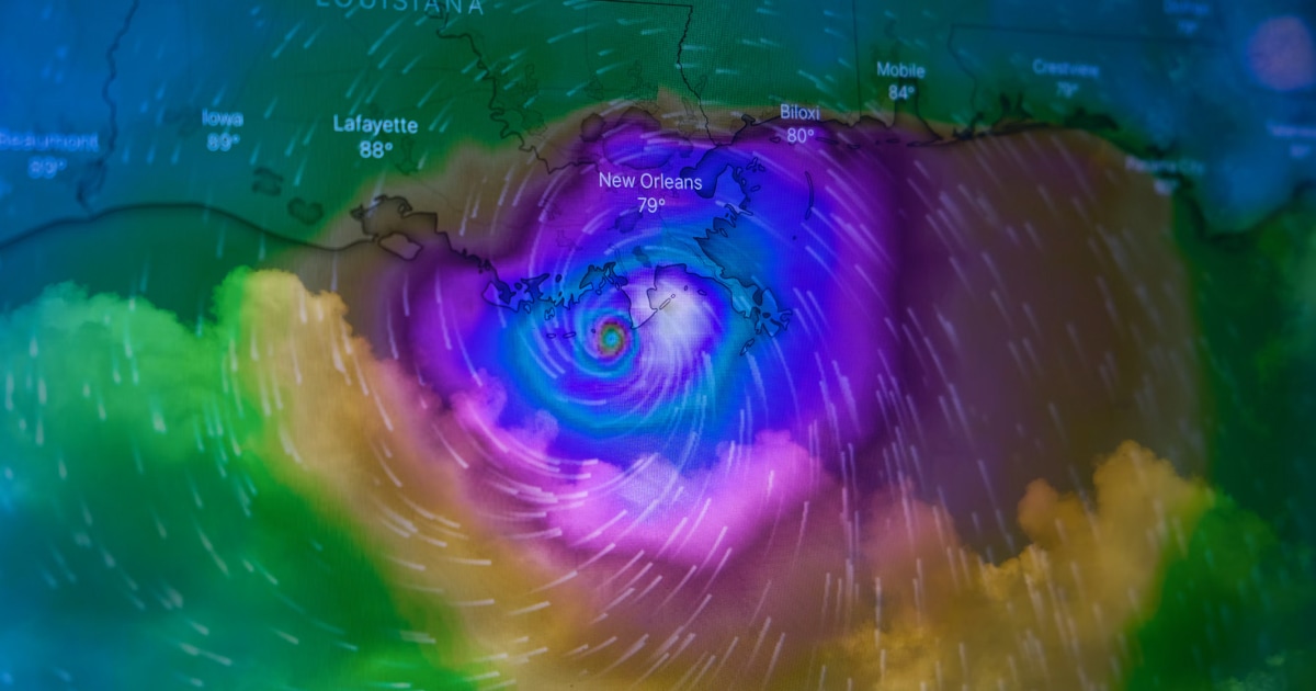 Weather radar map showing a large storm system in purple, green and yellow over the US Gulf Coast.